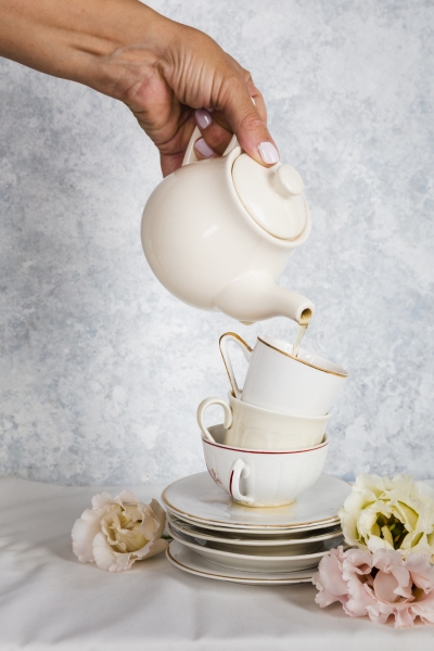 hand-holding-teapot-studio-shot